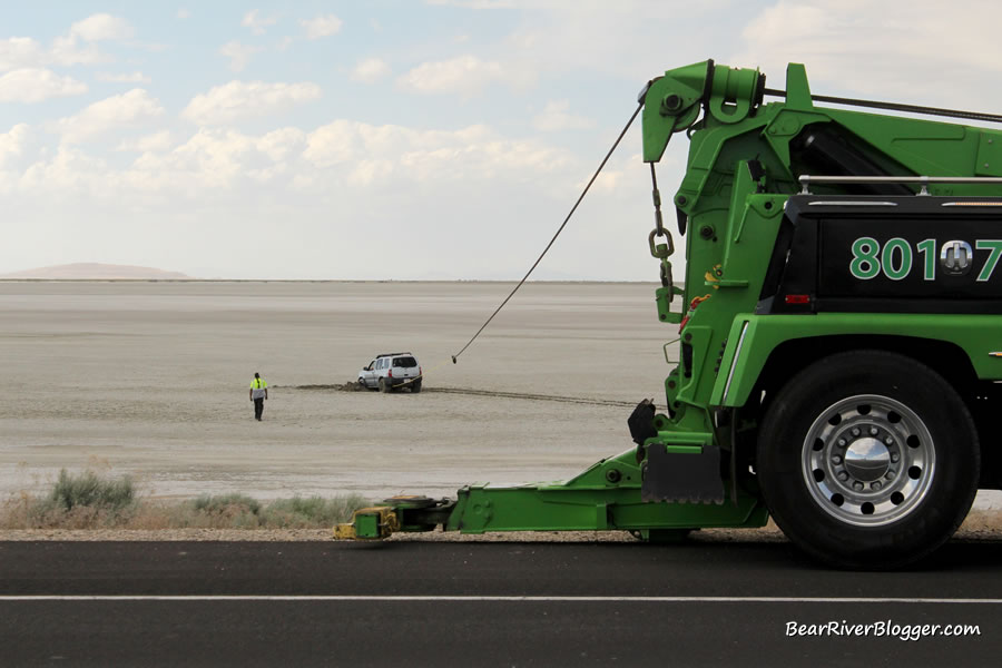 tow truck pulling a truck stuck in the mud on the great salt lake causeway