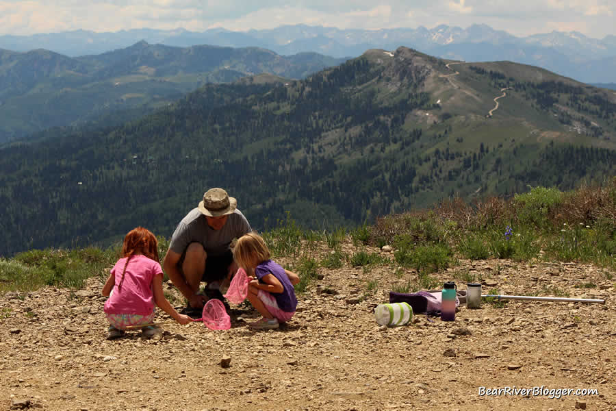 father and daughters learning about butterflies on a utah butterfly field trip