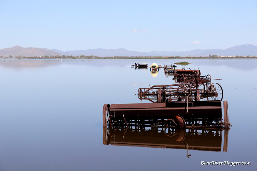 old farm equipment surrounded by flood waters from the Bear River