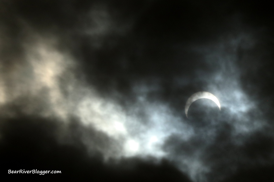 dark clouds around the partial solar eclipse on the bear river migratory bird refuge