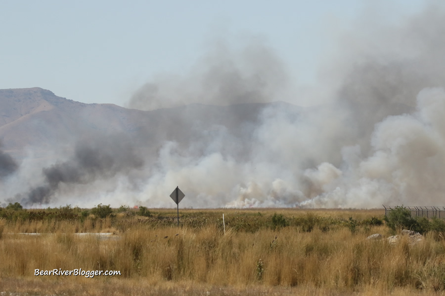 large smoke plumes from a prescribed burn on the bear river migratory bird refuge auto tour route.